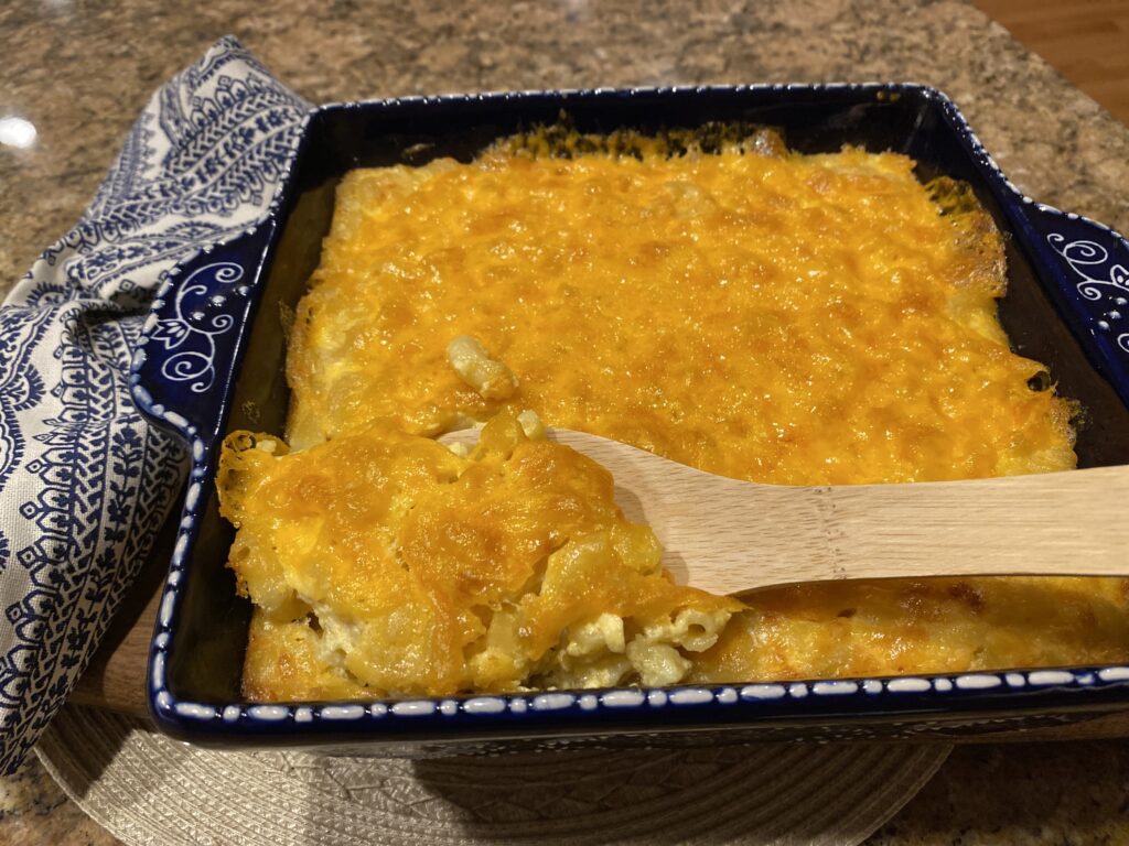 macaroni and cheese being scooped out 